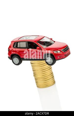 Rising car costs. Car on coins Stock Photo