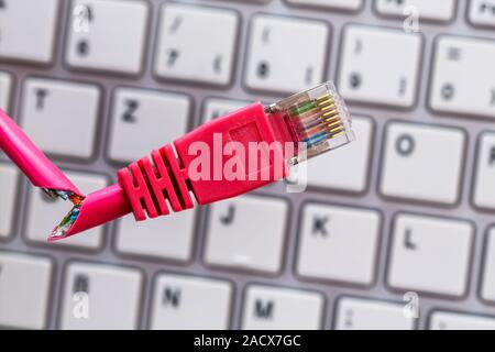 Defective network cable on keyboard Stock Photo