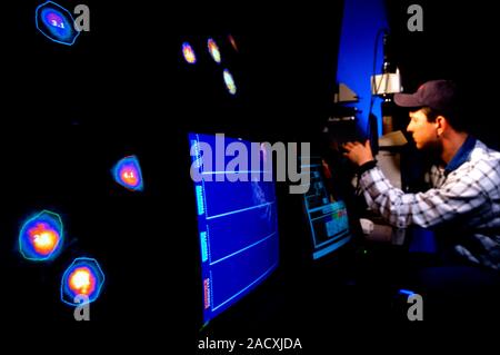 Brain activity fluorescence imaging. Biologist viewing fluorescent images of calcium in brain cells that are affected by oxidative stress. This study Stock Photo