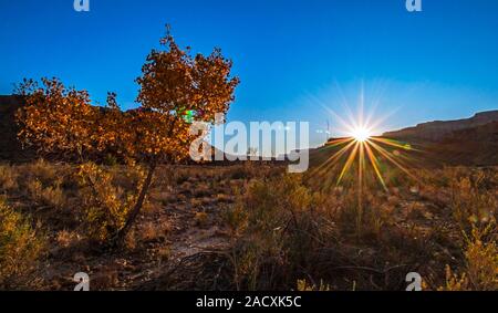 Vibramt Sunburst as sun sets over Vermillion Cliffs In Northern AZ During Fall season. Stock Photo