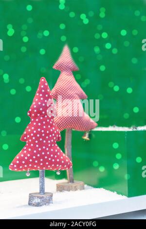 Fabric christmas tree on green background with beautiful bokeh. Handmade Christmas trees as a save nature concept. Greeting Christmas card. Stock Photo