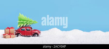Car Volkswagen Beetle with Christmas presents and tree over snow pillow Stock Photo
