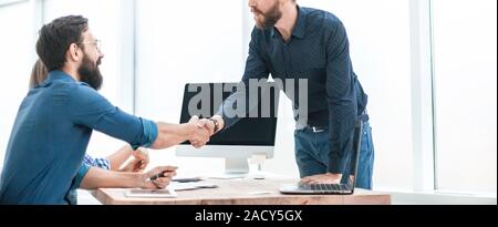 business people shaking hands over the Desk Stock Photo
