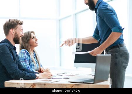 smiling man explaining that the employees of the Bank Stock Photo