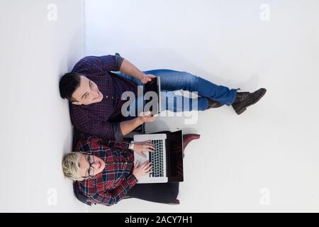 top view of  couple working on laptop computer at startup office Stock Photo