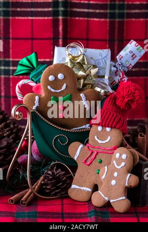 Close up view of a gingerbread family in a sleigh with a sack full of presents. Christmas concept. Stock Photo