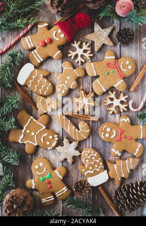 Premium Photo  Gingerbread cookies as stars shape for christmas, on a  parchment paper with pine cones and branches, dried slices of orange and  cinnamon sticks