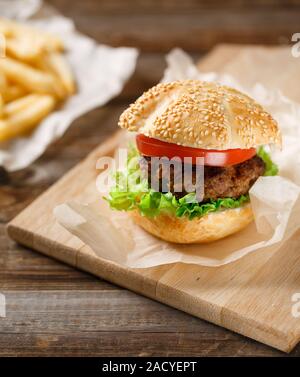 Hamburgers and French fries on the wooden tray Stock Photo - Alamy