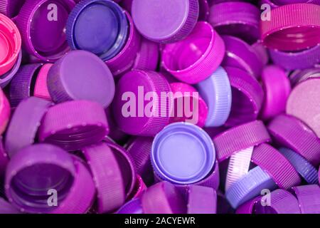 The purple plastic lid that is left over from the bottles are collected to be recycled into other items for reuse. Stock Photo