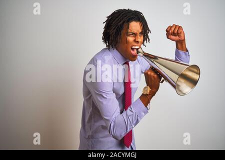 Young african american businessman screaming using vintage megaphone Stock Photo