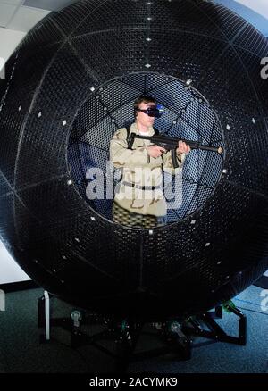 VirtuSphere military training aid. Soldier training inside the VirtuSphere, a nine-foot plastic ball that sits on wheels enabling unlimited rotation i Stock Photo