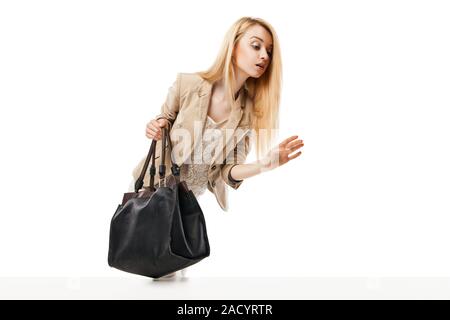 Young excited woman looking at the shop window Stock Photo