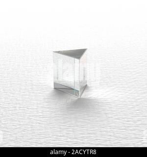 A plain glass prism showing refraction and reflection of the paper surface upon which it is sitting. In Isaac Newton's time, it was believed that whit Stock Photo
