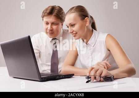Business couple using laptop Stock Photo