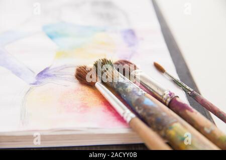 paint brushes lying on painted background Stock Photo