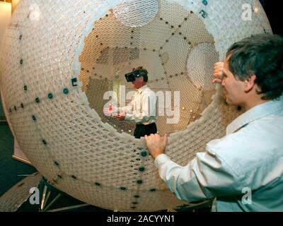 Virtusphere virtual reality sphere. Man demonstrating the Virtusphere, a locomotion platform that allows users to be completely immersed into an inter Stock Photo