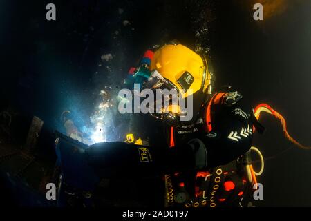 Commercial diver welding. Commercial diver using an electric arc welder during training. Photographed at the Underwater Centre, Fort William, Scotland Stock Photo