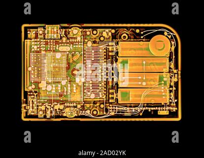 Coloured x-ray image of a handheld computer game device. Stock Photo