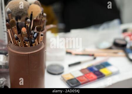 set of different brushes in a case. Make-up artist is painted on the table at the workplace. Makeup brushes. Workplace makeup artist. Mirror makeup ta Stock Photo