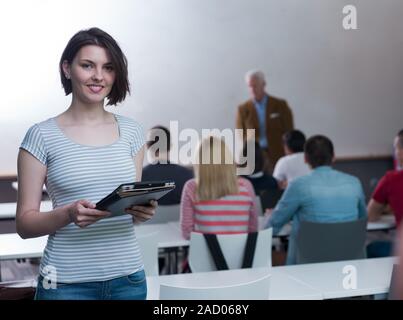 portrait of happy female student in classroom Stock Photo