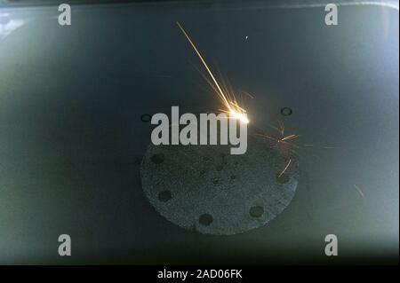 3D printing spacecraft engine parts. Close-up of a prototype rocket engine part being made in a 3d printer that uses the process of selective laser me Stock Photo