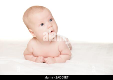 Little boy lying on stomach and looking aside Stock Photo