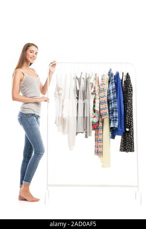 Side view of beautiful young brunette near clothes hanger Stock Photo