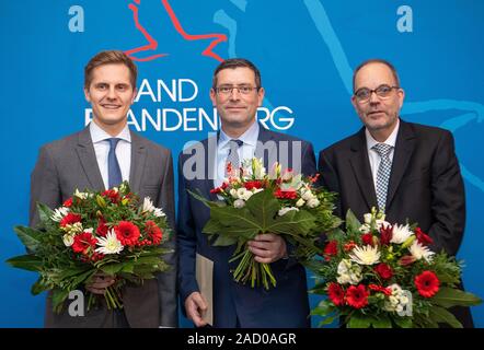 Potsdam, Germany. 03rd Dec, 2019. Benjamin Grimm (l-r, SPD), new State Secretary in the Brandenburg State Chancellery, Uwe Schüler (CDU), new State Secretary in the Brandenburg Ministry of the Interior, and Michael Ranft (non-party), new State Secretary in the Brandenburg Ministry of Social Affairs, Health, Integration and Consumer Protection, are standing in the State Chancellery on the occasion of their appointment. Credit: Monika Skolimowska/dpa-Zentralbild/dpa/Alamy Live News Stock Photo