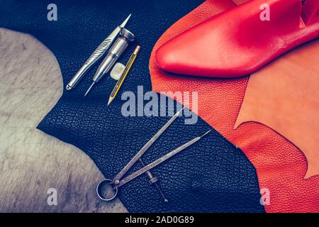 Shoemaker's work desk. Tools and leather at cobbler workplace. Shoes, leather, shoemaking tools and set of leather craft tools . Shoes maker tools on Stock Photo