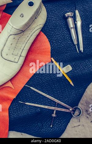 Shoemaker's work desk. Tools and leather at cobbler workplace. Shoes, leather, shoemaking tools and set of leather craft tools . Shoes maker tools on Stock Photo