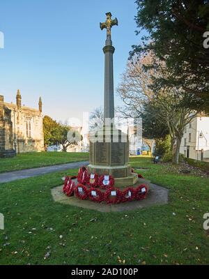 Wreaths of remembrance around the Cenotaph in the grounds of All Saints Church, Driffield, East Riding of Yorkshire, England, UK, GB.
