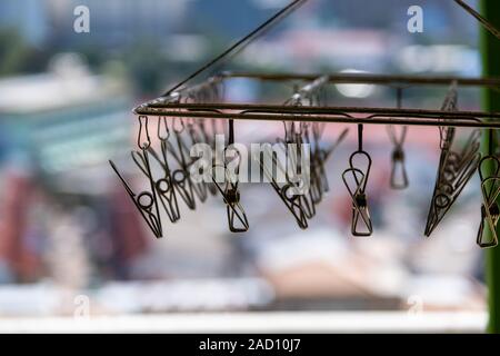 The metal clothespins hanging with wire on blur background. Stock Photo