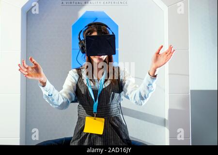 Diabetes virtual reality demonstration. Delegates using virtual reality equipment at a conference on diabetes. Equipment like this is used to simulate Stock Photo