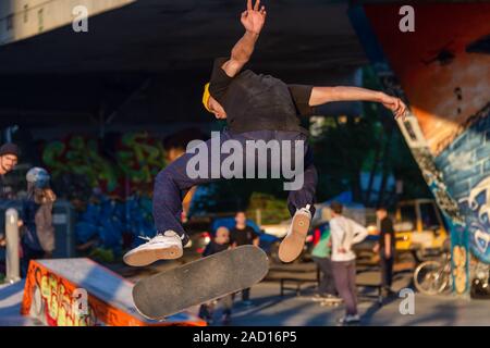 Montreal, Canada - 19 September 2019: Young Skateboarder doing a jumping trick at the Van Horne skatepark Stock Photo