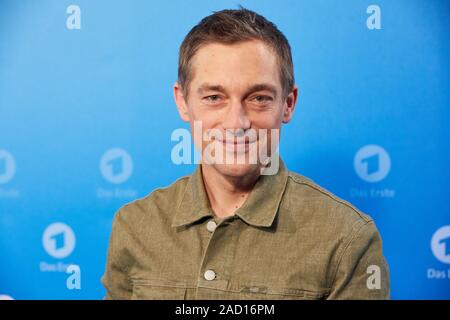 Hamburg, Germany. 03rd Dec, 2019. Volker Bruch, actor, stands in front of a logo wall at a photo shoot on the occasion of the ARD annual press conference. Credit: Georg Wendt/dpa/Alamy Live News Stock Photo