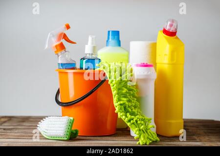 Bucket with cleaning items on light background Stock Photo
