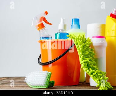 Bucket with cleaning items on light background Stock Photo