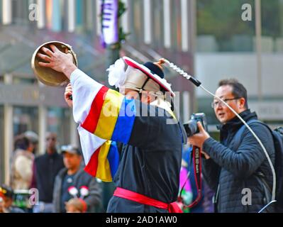 Korean drummers and bandleader marching in the Thanksgiving Day parade in Charlotte NC Stock Photo