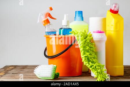 Bucket with cleaning items on light background Stock Photo