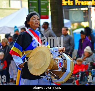 Korean drummers and bandleader marching in the Thanksgiving Day parade in Charlotte NC Stock Photo