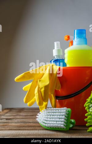 Bucket with cleaning items on light background Stock Photo
