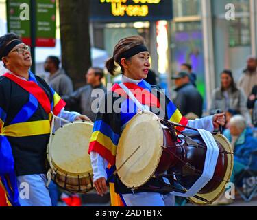 Korean drummers and bandleader marching in the Thanksgiving Day parade in Charlotte NC Stock Photo