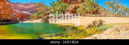 Banner panorama of Ormiston Gorge Water Hole with ghost gum in West MacDonnell Ranges, Northern Territory, Australia. Ormiston Gorge is a great place Stock Photo