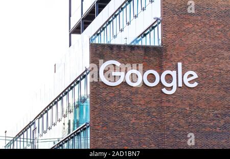 Google office building exterior, European headquarters in Dublin, Ireland. With Google logo and signage. Red brick and glass offices, copy space sky Stock Photo
