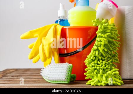 Bucket with cleaning items on light background Stock Photo