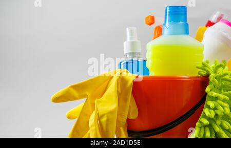 Bucket with cleaning items on light background Stock Photo