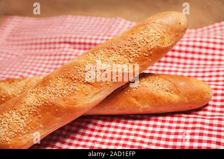 French bread isolated on checkered napkin Stock Photo