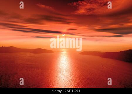 Partial solar eclipse. View across a bay towards the Sun shining over the horizon during a partial solar eclipse. Solar eclipses occur when the Moon p Stock Photo
