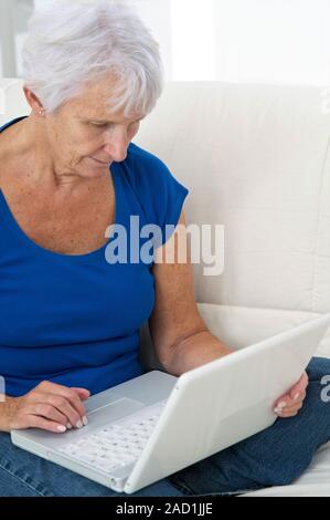 Older lady using laptop. Stock Photo