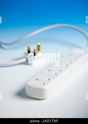 Extension cable. An electrical cable fitted with a four-socket splitter box. This enables up to four appliances to be connected to a single wall outle Stock Photo